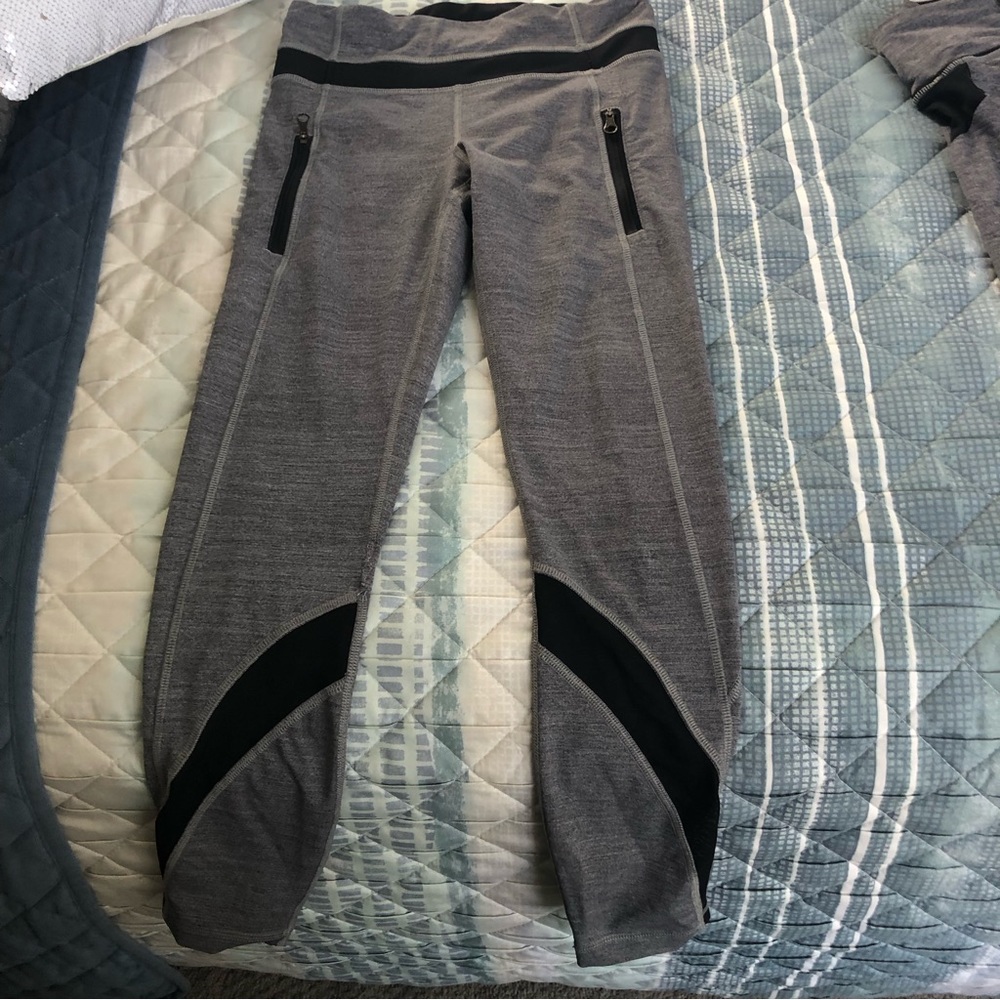 Lululemon gray and black Womens leggings.  Size 4, side zippers, black netting